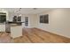 Open kitchen and dining area featuring hard wood floors, granite countertops, and stainless steel appliances at 3024 Half Shell Way, Las Vegas, NV 89128