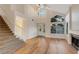Spacious living room featuring hardwood floors, high ceilings, staircase, and fireplace at 3024 Half Shell Way, Las Vegas, NV 89128