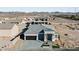 Areal view of single-story home with stone facade, paved driveway, and mountain views at 311 S Lisbon St, Henderson, NV 89015