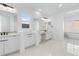 Bright bathroom with double vanity, white cabinetry, and a modern freestanding tub at 311 S Lisbon St, Henderson, NV 89015