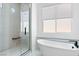 Bright bathroom featuring a modern soaking tub and glass-enclosed shower at 311 S Lisbon St, Henderson, NV 89015