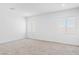 Bedroom with plush carpet, large windows, and neutral decor for a serene space at 311 S Lisbon St, Henderson, NV 89015
