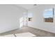 Clean bedroom space with neutral carpet, white walls, and plenty of natural light at 311 S Lisbon St, Henderson, NV 89015