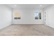 Spacious bedroom with neutral carpet, white walls, and dual windows providing natural light at 311 S Lisbon St, Henderson, NV 89015