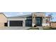 Beautiful single-story home with a modern exterior, a two-car garage, and desert landscaping at 311 S Lisbon St, Henderson, NV 89015