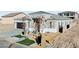 A front view of a home that includes the front entryway, a garage and desert landscaping at 311 S Lisbon St, Henderson, NV 89015