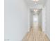 Long hallway with recessed lighting and wood-look flooring at 311 S Lisbon St, Henderson, NV 89015
