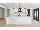 Spacious kitchen with a large island, stylish lighting, and stainless steel appliances at 311 S Lisbon St, Henderson, NV 89015