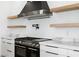 Modern kitchen showcasing stainless steel appliances, floating shelves, and marble countertops at 311 S Lisbon St, Henderson, NV 89015
