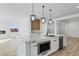 Kitchen featuring a marble island, stainless steel appliances, and modern pendant lights at 311 S Lisbon St, Henderson, NV 89015