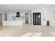 Open-concept kitchen with island, stainless steel hood, and modern lighting fixtures at 311 S Lisbon St, Henderson, NV 89015