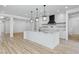 Bright, open kitchen featuring a large island, modern lighting, and stainless steel appliances at 311 S Lisbon St, Henderson, NV 89015