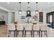 Modern kitchen with a large island, pendant lighting, and stainless steel appliances at 311 S Lisbon St, Henderson, NV 89015