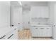 Well-lit laundry room with white cabinets and modern countertops at 311 S Lisbon St, Henderson, NV 89015