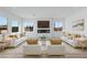 Contemporary living room with white sofas, fireplace, and large windows at 311 S Lisbon St, Henderson, NV 89015