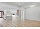 Bright, open-concept living room boasts wood floors, modern lighting, and seamless flow into the kitchen at 311 S Lisbon St, Henderson, NV 89015