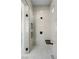A beautifully tiled shower features a rainfall shower head and a built-in bench at 311 S Lisbon St, Henderson, NV 89015
