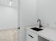 Modern wet bar featuring a sleek countertop and black fixtures at 311 S Lisbon St, Henderson, NV 89015