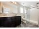 Modern bathroom features a double vanity, tiled floors, shower with glass door, and a separate toilet at 3158 Teaderman Walk, Henderson, NV 89044