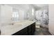 Bright bathroom featuring dark cabinets, a white countertop, and a modern black and white shower curtain at 3158 Teaderman Walk, Henderson, NV 89044