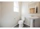 Clean half bathroom with pedestal sink and natural light from a window at 3158 Teaderman Walk, Henderson, NV 89044