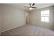 This bedroom features a modern ceiling fan, neutral walls, plush carpeting, and access to an entryway at 3158 Teaderman Walk, Henderson, NV 89044