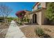 Charming exterior view showcasing the home's landscape and well-manicured pathway at 3158 Teaderman Walk, Henderson, NV 89044