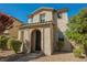 Charming two-story home with stucco exterior, arched entry, and well-maintained landscaping at 3158 Teaderman Walk, Henderson, NV 89044