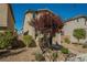 Inviting two-story home showcasing low maintenance landscaping and a charming front yard tree at 3158 Teaderman Walk, Henderson, NV 89044