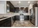 Well-equipped kitchen featuring stainless steel appliances and ample dark cabinet space at 3158 Teaderman Walk, Henderson, NV 89044