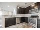 Elegant kitchen with stainless steel appliances and dark wood cabinetry, creating a sophisticated cooking space at 3158 Teaderman Walk, Henderson, NV 89044