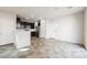 Open-concept living area adjacent to a modern kitchen, featuring tile floors and ample natural light at 3158 Teaderman Walk, Henderson, NV 89044