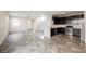 Open-concept living space featuring a kitchen with stainless steel appliances and access to staircase at 3158 Teaderman Walk, Henderson, NV 89044