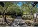 Shaded community walkway lined with mature trees and lush landscaping, creating a serene outdoor space at 3158 Teaderman Walk, Henderson, NV 89044