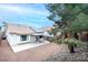 Home's backyard features gravel landscaping, covered patio, and solar panels at 3643 Spring Willow Ct, Las Vegas, NV 89147