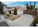 Exterior view of house features desert landscaping, two-car garage, and solar panels at 3643 Spring Willow Ct, Las Vegas, NV 89147