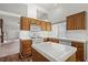 Functional kitchen boasts laminate floors, white appliances, and ample counter space at 3643 Spring Willow Ct, Las Vegas, NV 89147