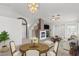 Open living room with chandelier, fireplace, and access to the dining area at 3643 Spring Willow Ct, Las Vegas, NV 89147