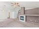 Spacious living room featuring neutral carpet, ceiling fan, and a fireplace at 3643 Spring Willow Ct, Las Vegas, NV 89147