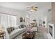 Bright living room with fireplace, ceiling fan, and elegant furnishings at 3643 Spring Willow Ct, Las Vegas, NV 89147