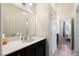 Well-lit bathroom with a vanity featuring a white countertop and black cabinets at 369 Monique Springs St, Henderson, NV 89014