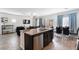 Open floorplan kitchen with granite island, dark cabinets, and stainless steel dishwasher at 369 Monique Springs St, Henderson, NV 89014
