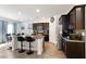 Open-concept kitchen features dark cabinets, granite counters, and stainless steel appliances at 369 Monique Springs St, Henderson, NV 89014