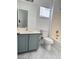 Bathroom featuring gray vinyl flooring, bath/shower combo, and a blue vanity at 3805 Carisbrook Dr, North Las Vegas, NV 89081