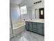 Bathroom featuring a soaking tub, walk-in shower, dual vanity, and marble tile floors at 3805 Carisbrook Dr, North Las Vegas, NV 89081