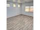 Bedroom with wood-look tile floors, natural lighting, and a vaulted ceiling at 3805 Carisbrook Dr, North Las Vegas, NV 89081