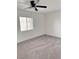 A well-lit bedroom includes a ceiling fan and a window offering natural light at 3805 Carisbrook Dr, North Las Vegas, NV 89081