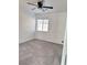 A simple bedroom with carpet, a ceiling fan, and a window at 3805 Carisbrook Dr, North Las Vegas, NV 89081