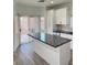 Bright kitchen with white cabinets, granite countertops, and sliding glass door to backyard at 3805 Carisbrook Dr, North Las Vegas, NV 89081