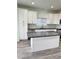 Bright kitchen features white cabinets, granite countertops, stainless steel appliances, and wood-look tile floors at 3805 Carisbrook Dr, North Las Vegas, NV 89081